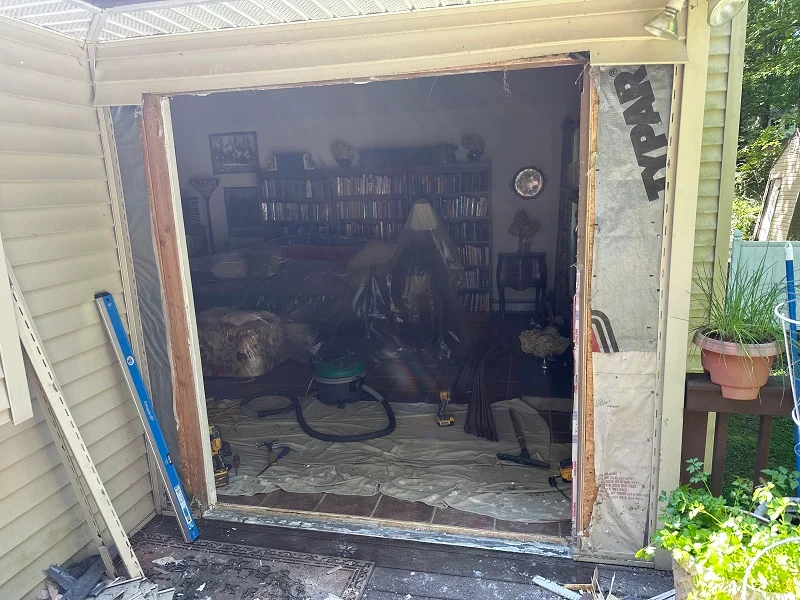 Removing vinyl siding to install this Harvey patio door in Beacon, NY